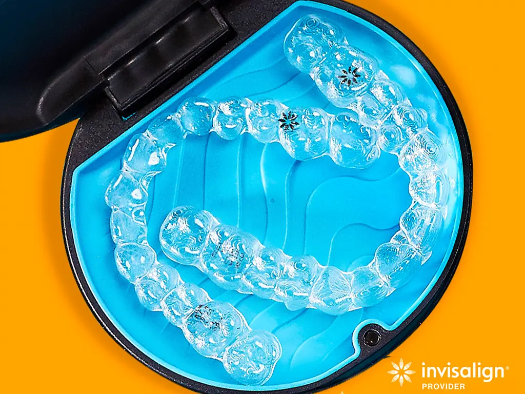 Invisalign aligner case on orange background